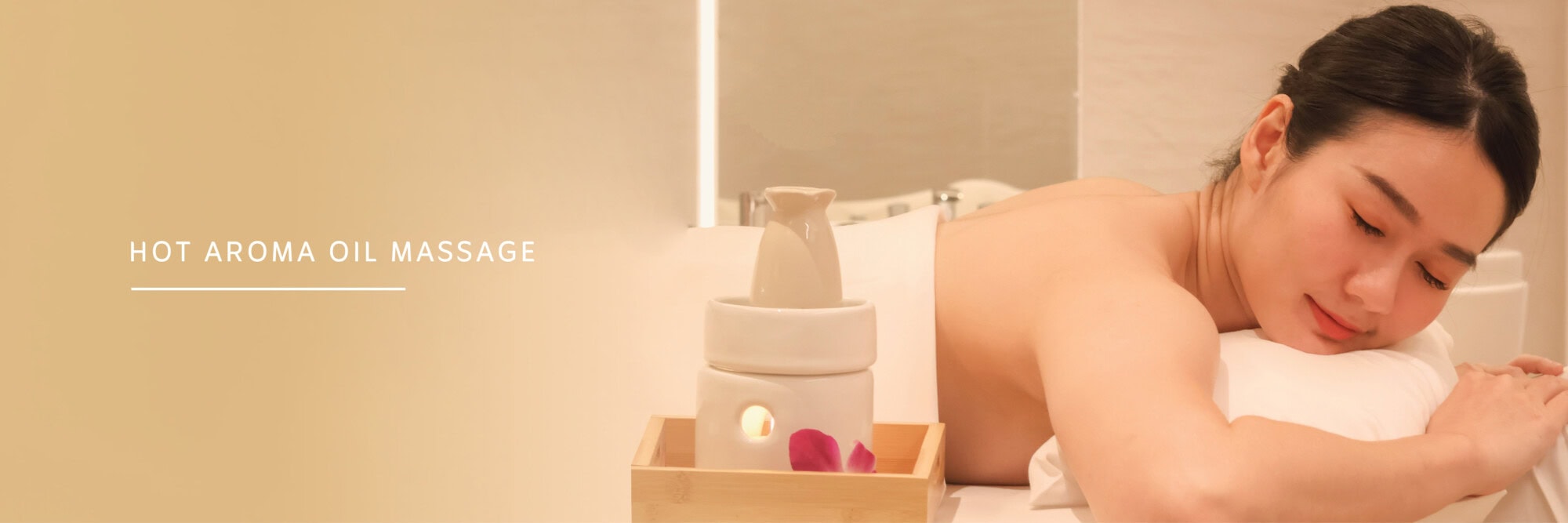 Relaxing woman receiving a hot aroma oil massage at Makkha Spa in Chiang Mai, offering the best spa experience in Chiang Mai for wellness and relaxation.