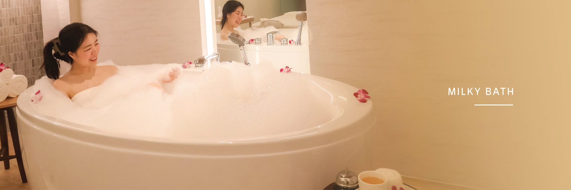 Calm women enjoying milky bath at Makkha Spa Chiangmai, relaxing spa treatment, luxurious bubble bath, women having a soothing bath experience, Makkha Spa best spa in Chiangmai.