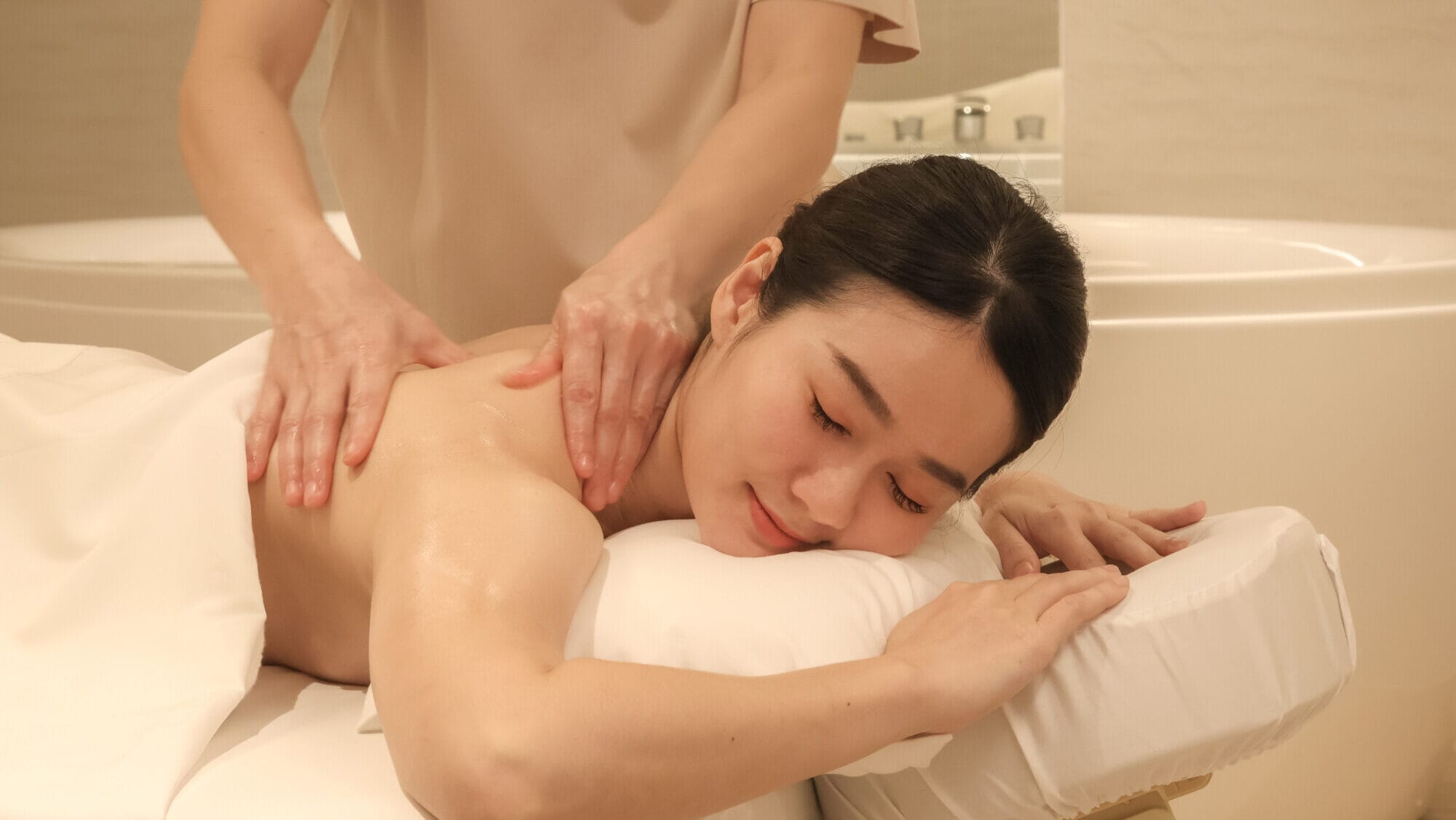 a woman receiving a massage at makkha spa, a top-reviewed spa service in Thailand