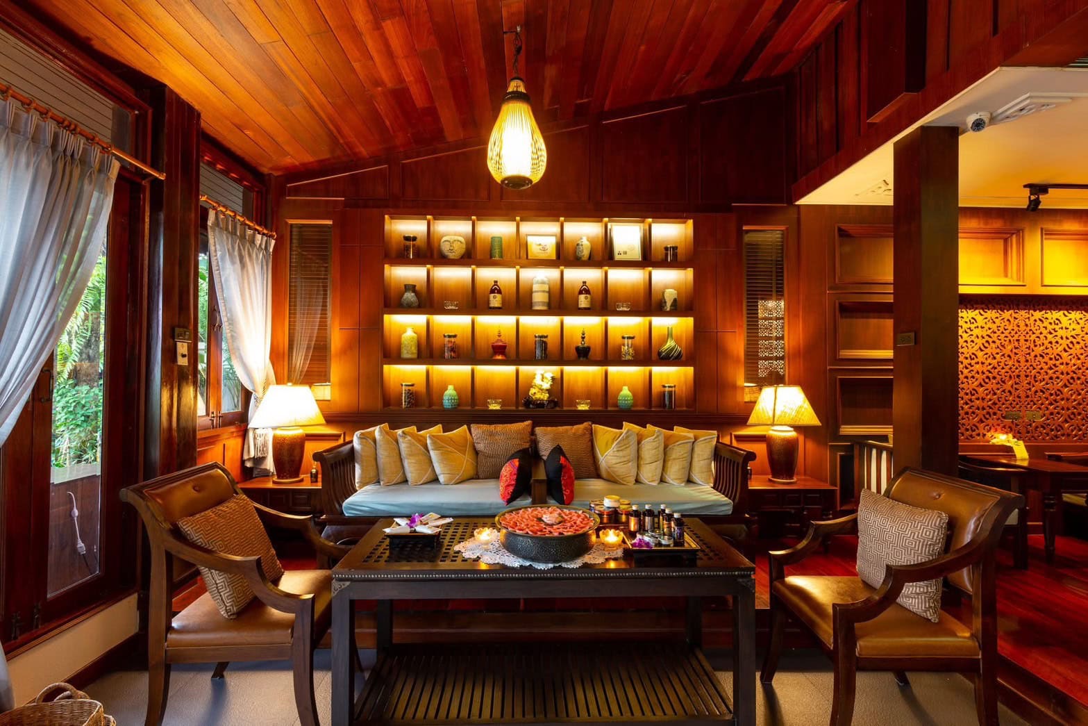 Luxurious wooden interior of Makkha spa and massage in Chiang Mai showcasing warm lighting, elegant decor, and a cozy, inviting atmosphere for relaxation and wellness.