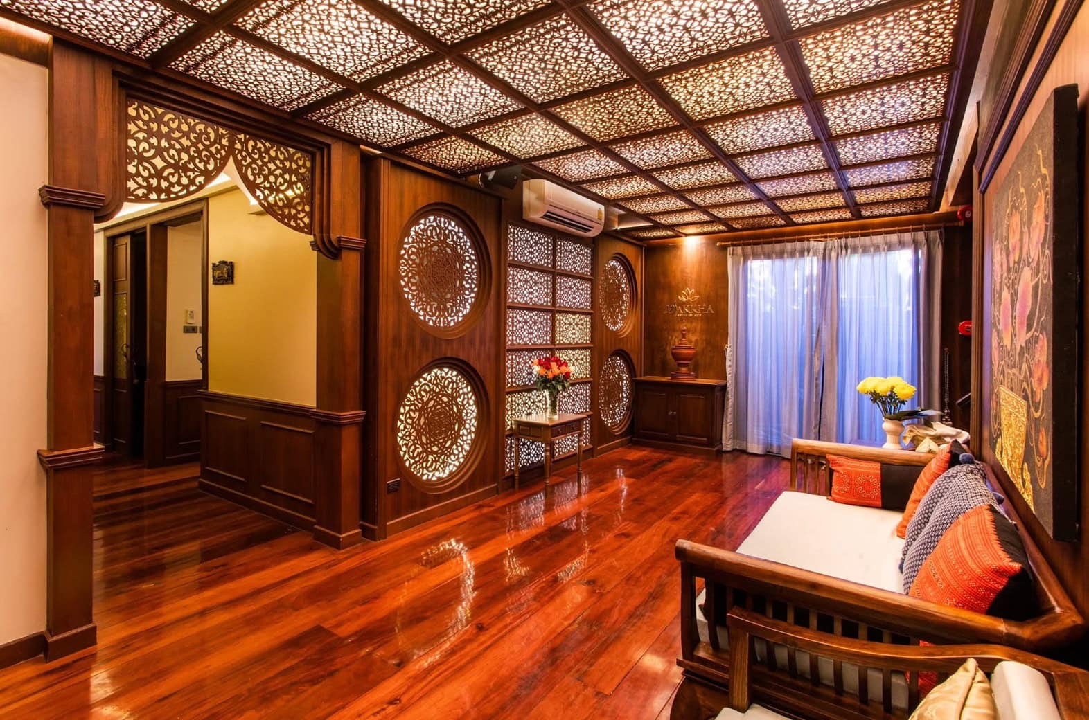 Luxurious traditional Thai spa lounge at Makkha Spa in Chiang Mai with ornate wooden carvings, cozy seating, and elegant decor. Perfect for relaxing and rejuvenating massages.