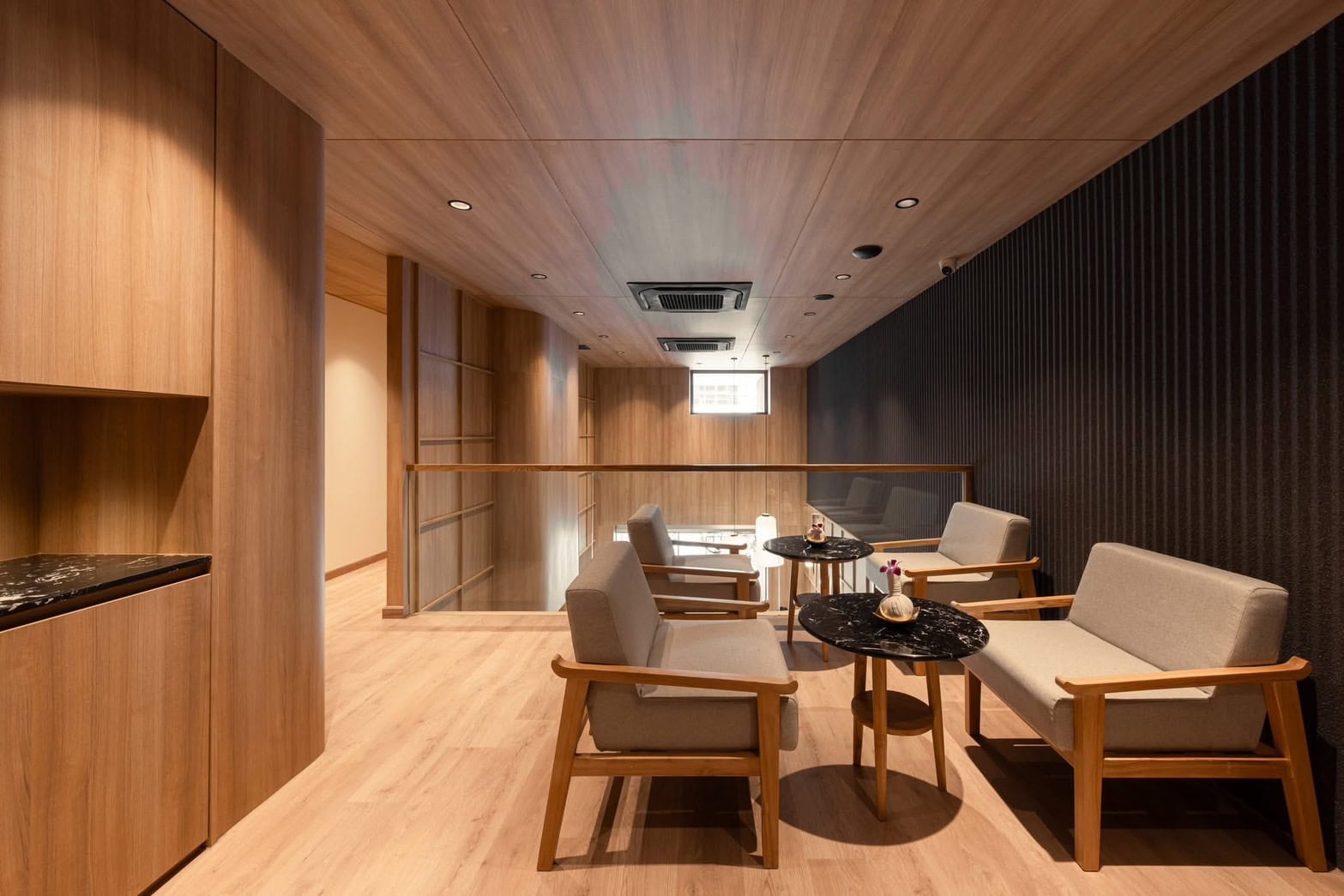 Serene spa lounge with wooden walls and comfortable seating, perfect for relaxation at Makkha Spa in Chiang Mai.