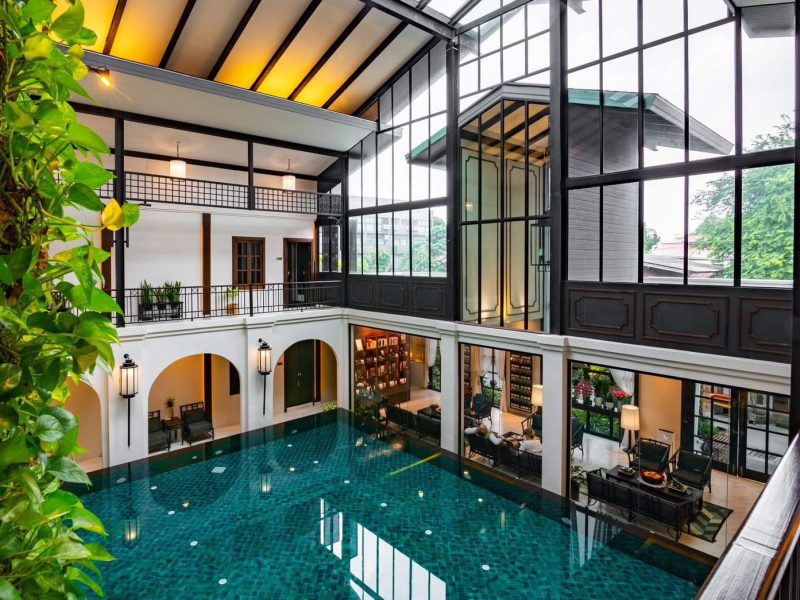 Luxurious indoor swimming pool at Makkha Health & Spa with elegant architecture and natural lighting in Chiang Mai.