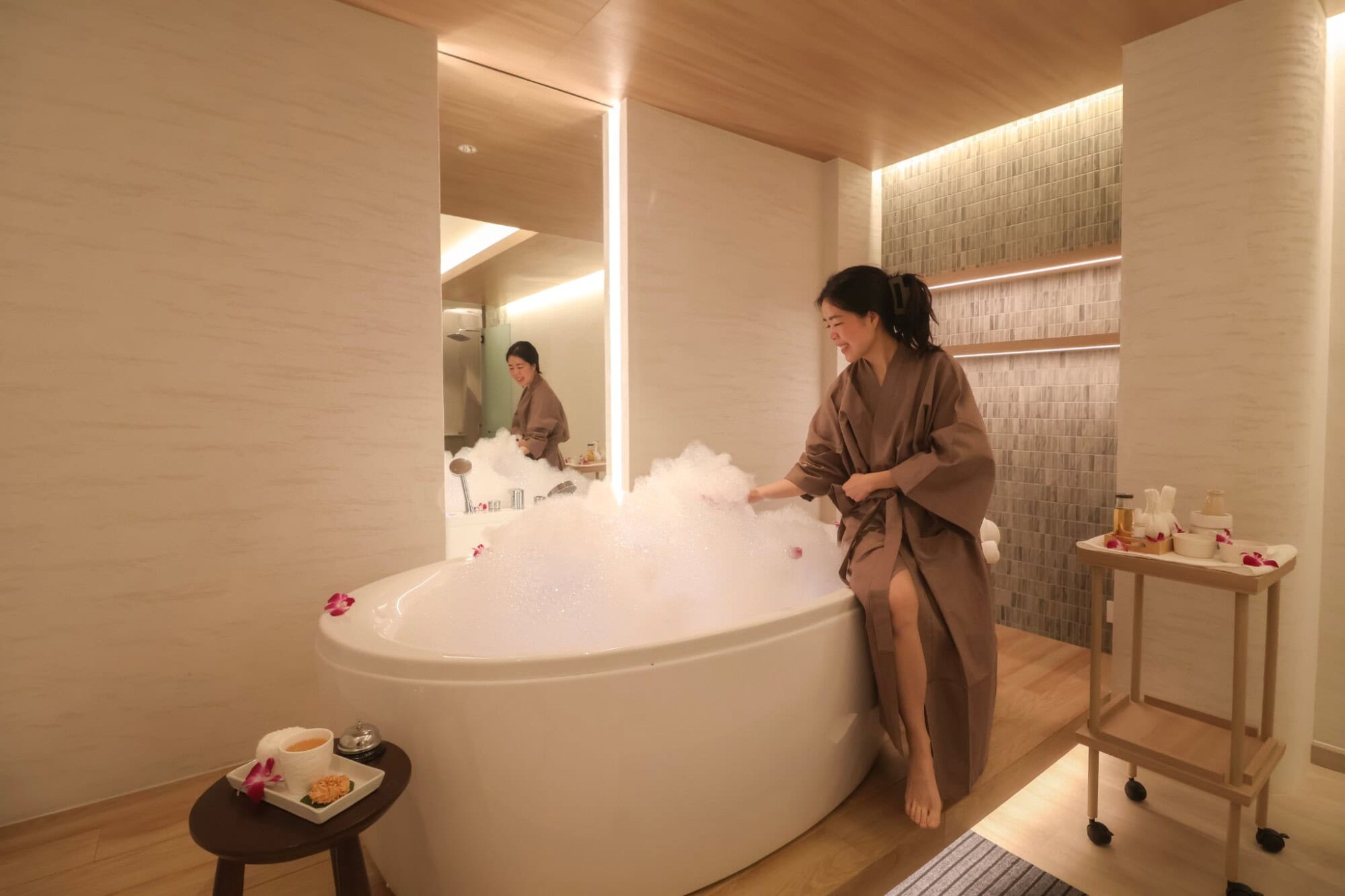 Relaxing women enjoying a bubble bath at Makkha Spa, Chiangmai's top wellness destination for luxurious spa treatments and authentic Thai massage in a serene, modern setting.