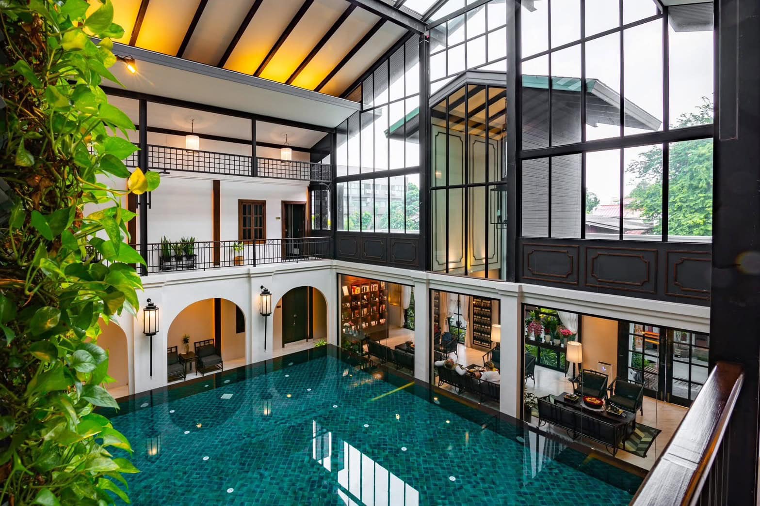 Luxurious indoor swimming pool at Makkha Health & Spa with elegant architecture and natural lighting in Chiang Mai.