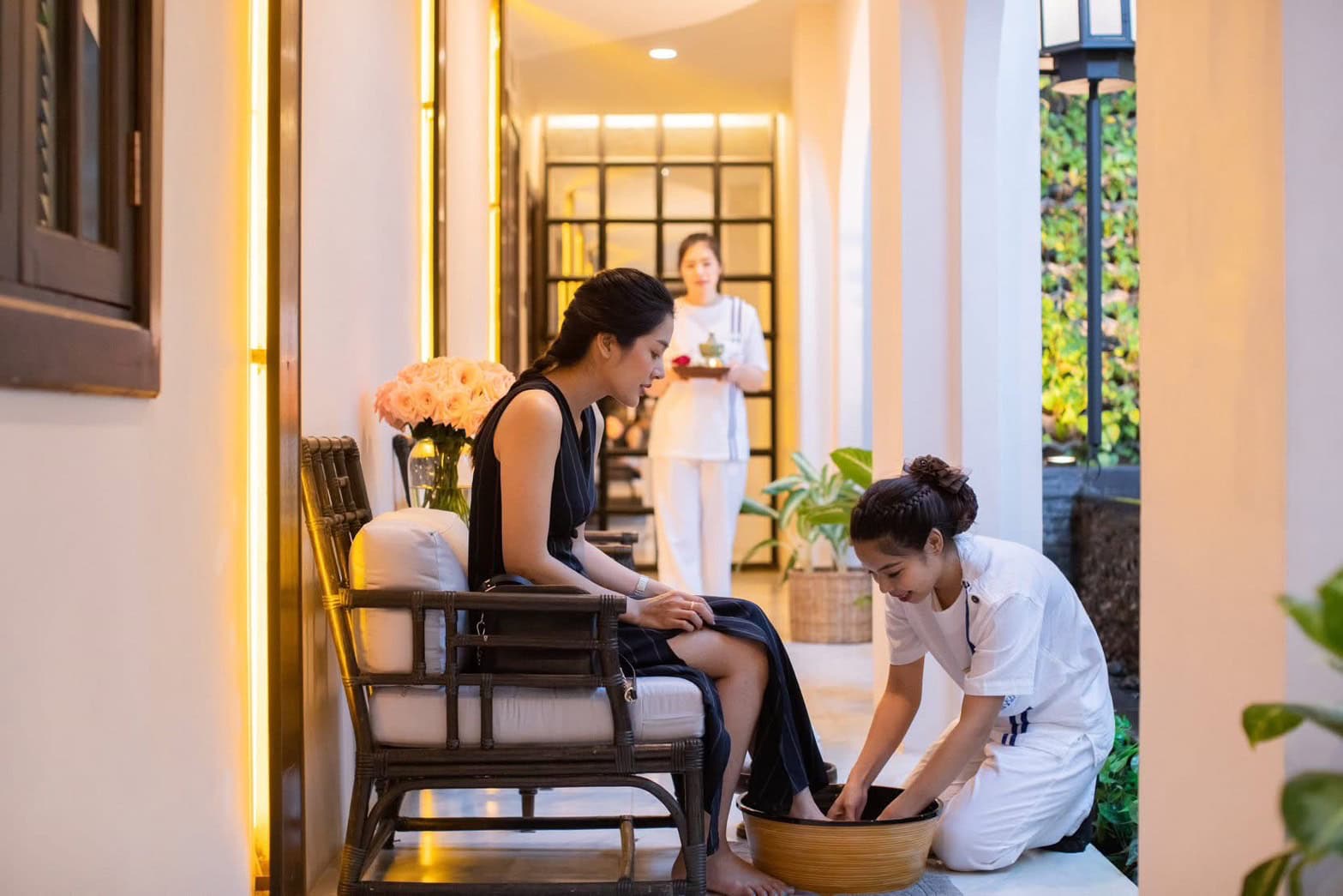 Relaxing Thai foot massage at Makkha Health & Spa in Chiang Mai, featuring a woman receiving foot treatment by a professional therapist in a tranquil, modern spa environment.