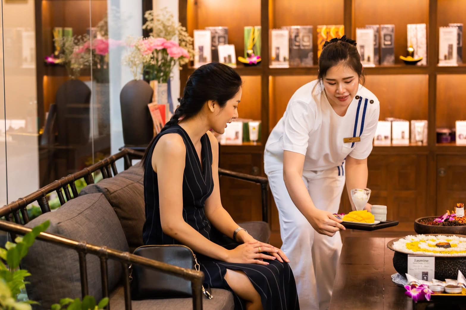 Luxurious spa treatment at Makkha Health & Spa Chiang Mai with an attentive therapist preparing a relaxing herbal therapy for a guest. Enjoy authentic Thai massage experiences in a serene setting.