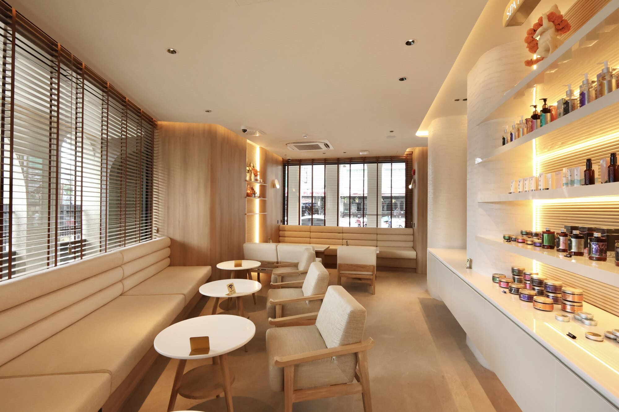 Luxurious Chiangmai spa waiting area with comfortable seating, wooden accents, and ambient lighting for relaxation at Makkha Spa.