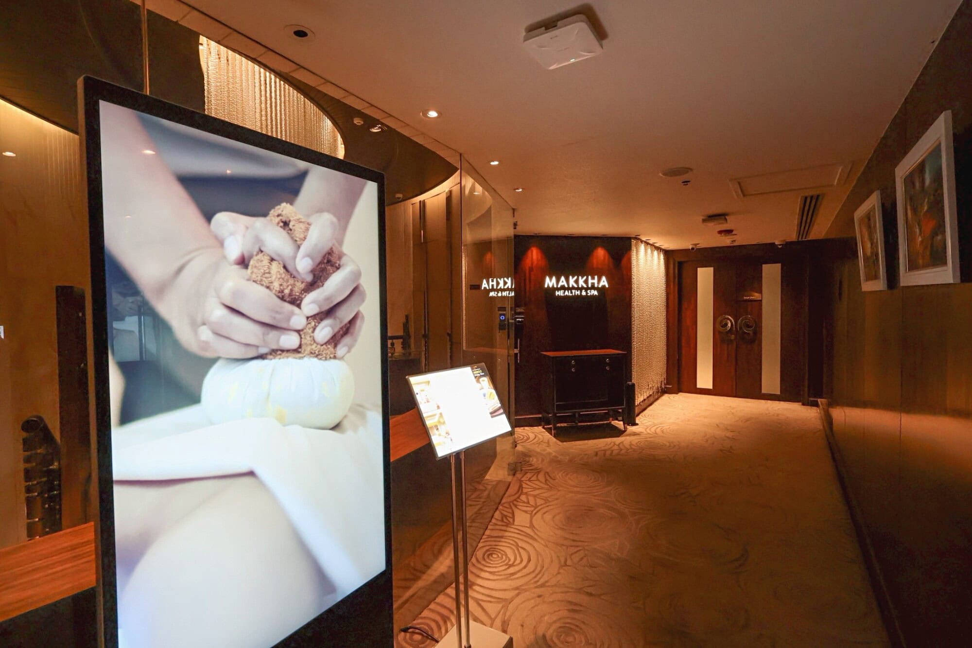 A calming spa reception area at Makkha Spa Chiangmai, featuring warm lighting, elegant decor, and a welcoming atmosphere perfect for relaxation and wellness experiences.
